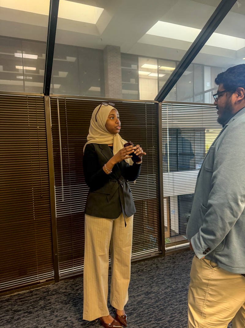 Two Arsi Global Inc. team members talking in the office lobby