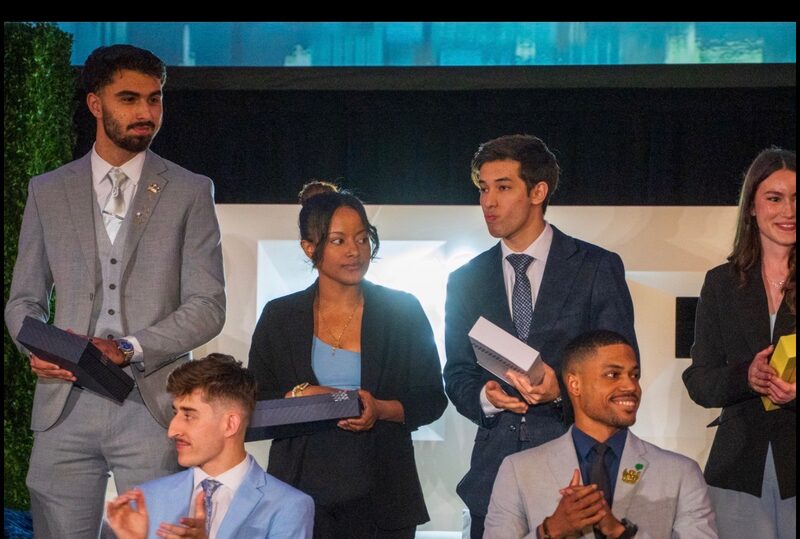 Team members being recognised on stage at a company awards event